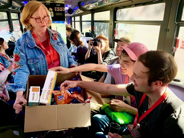 A guide handing out snacks to smiling guests on the tour bus