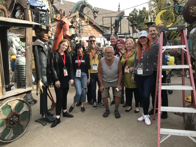 A tour group among folk-art sculptures in a Wichita art yard