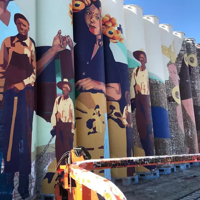 Painted figures across Wichita grain silos